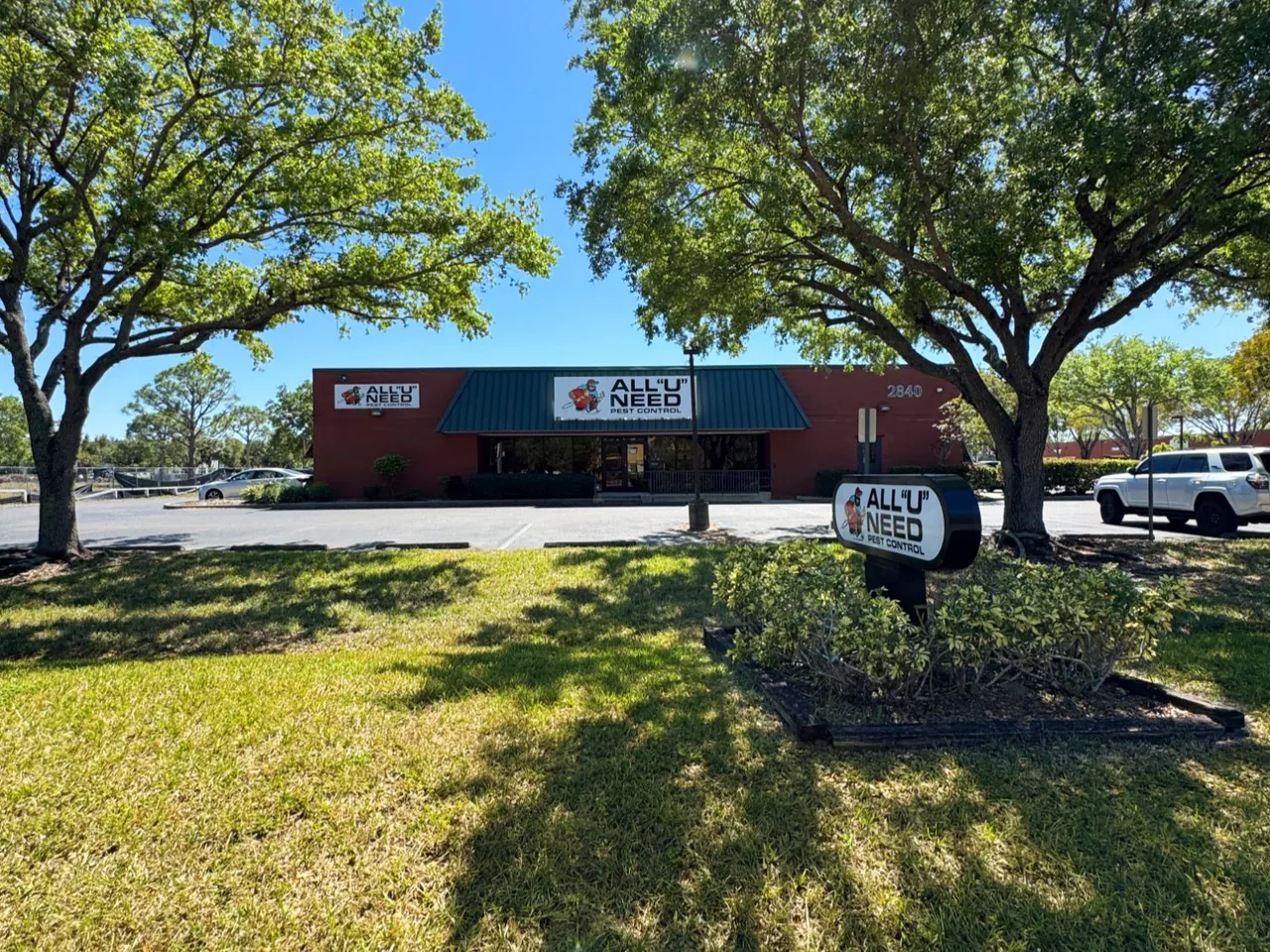 All U Need Pest Control headquarters building with branded signage
